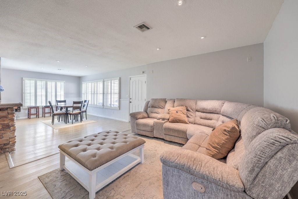 2240 Grayson Circle Henderson, NV 89014 - Photo 11 of 38 Living area with light wood finished floors and a textured ceiling