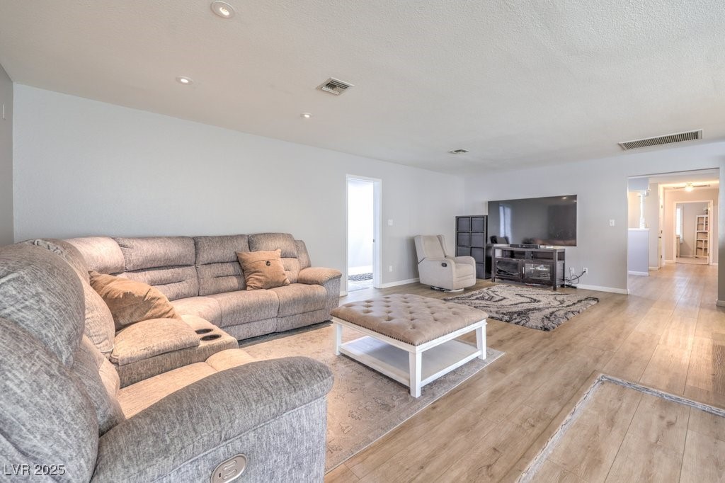 2240 Grayson Circle Henderson, NV 89014 - Photo 12 of 38 Living room with wood finished floors and a textured ceiling