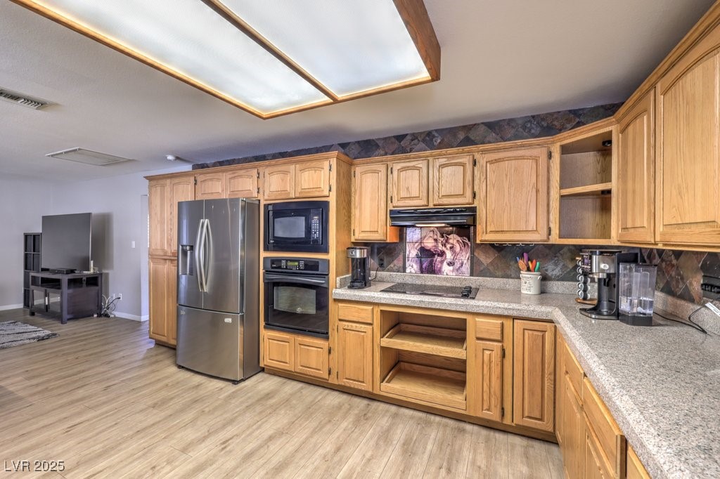 2240 Grayson Circle Henderson, NV 89014 - Photo 17 of 38 Kitchen with open shelves, black appliances, backsplash, light wood-type flooring, and under cabinet range hood
