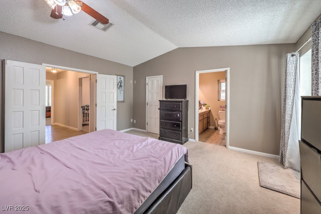 2240 Grayson Circle Henderson, NV 89014 - Photo 20 of 38 Bedroom featuring multiple windows, lofted ceiling, a textured ceiling, light carpet, and a ceiling fan