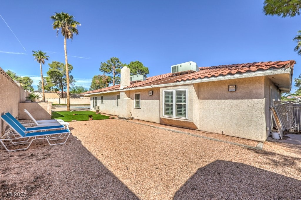2240 Grayson Circle Henderson, NV 89014 - Photo 37 of 38 Rear view of property featuring a fenced backyard, stucco siding, a tiled roof, and a pool