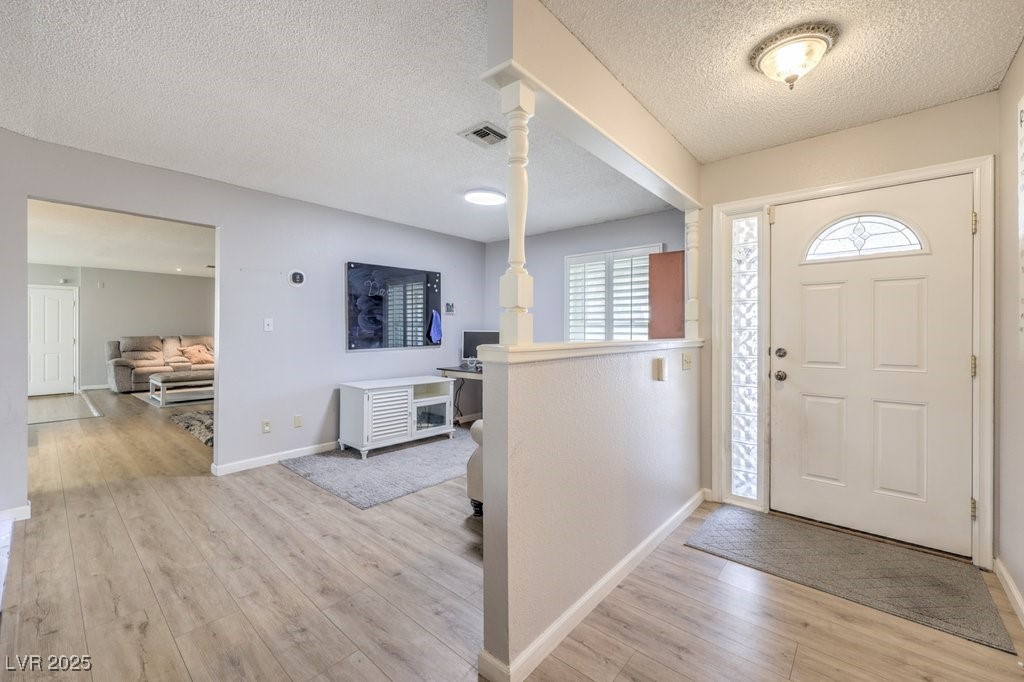 2240 Grayson Circle Henderson, NV 89014 - Photo 5 of 38 Foyer with light wood finished floors and a textured ceiling