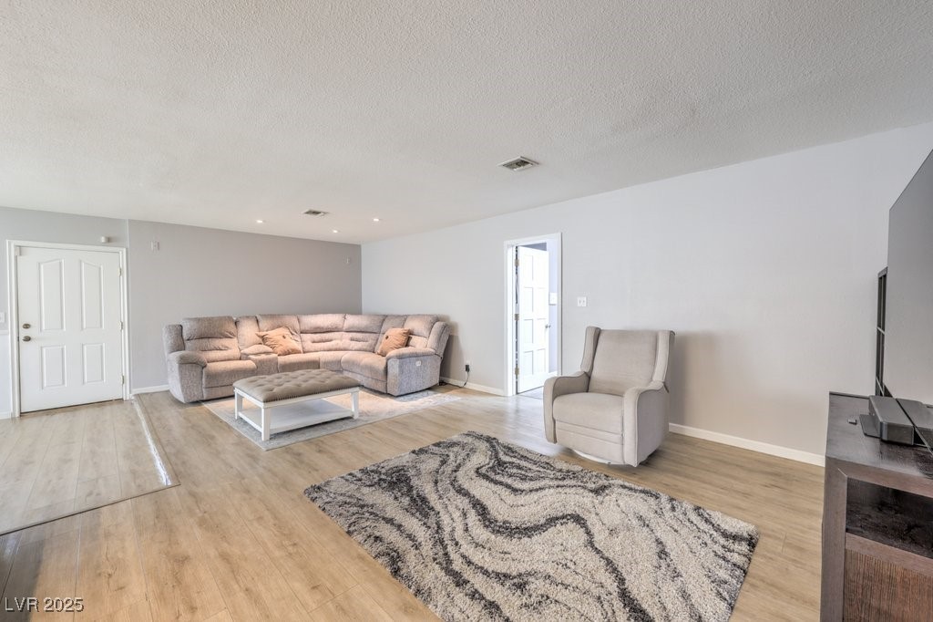 2240 Grayson Circle Henderson, NV 89014 - Photo 10 of 38 Living room with light wood finished floors and a textured ceiling