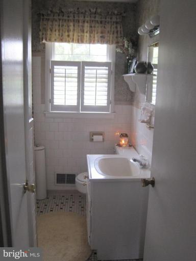 311 Bynum Ridge Road Forest Hill, MD 21050 - Photo 5 of 12 a bathroom with a sink and a mirror