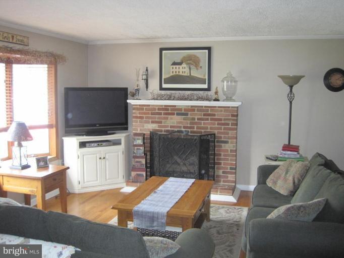 311 Bynum Ridge Road Forest Hill, MD 21050 - Photo 7 of 12 a living room with furniture and a fireplace