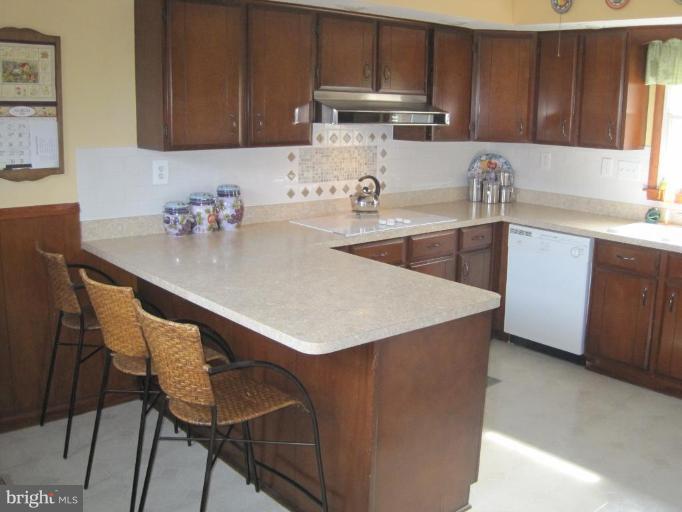 311 Bynum Ridge Road Forest Hill, MD 21050 - Photo 10 of 12 a kitchen with a table chairs sink and cabinets