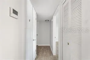 a view of a hallway with wooden floor