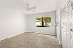 an empty room with windows and closet