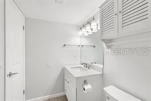 a bathroom with a sink toilet and vanity