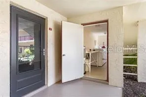 a view of a lake with table and chairs