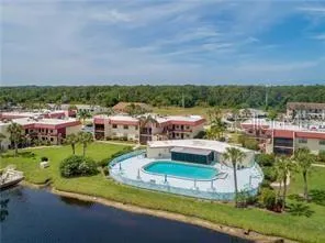an aerial view of a house with a garden and lake view