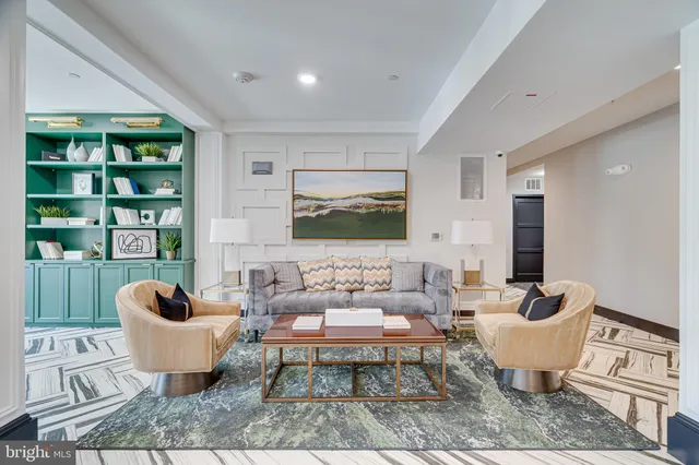 a living room with furniture and a book shelf