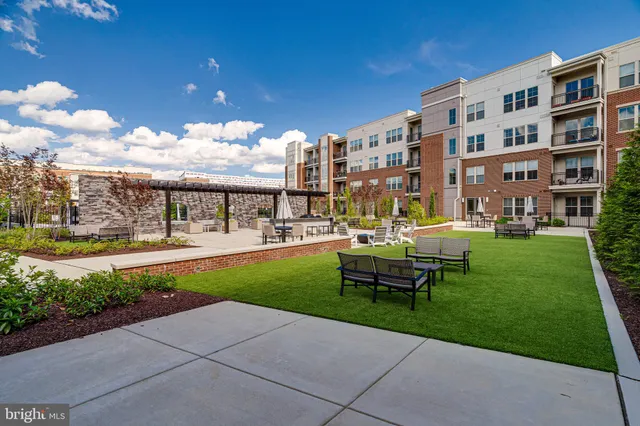 a swimming pool with outdoor seating and yard