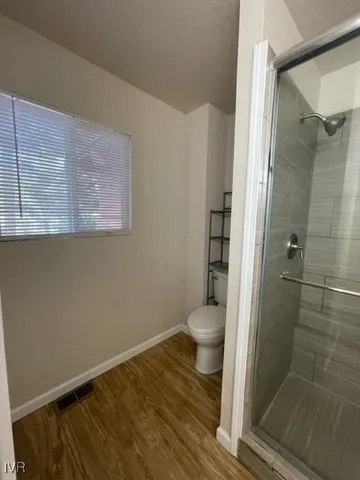 a bathroom with a toilet and shower