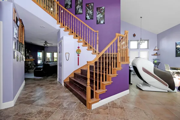 a kitchen with a sink a refrigerator and chairs
