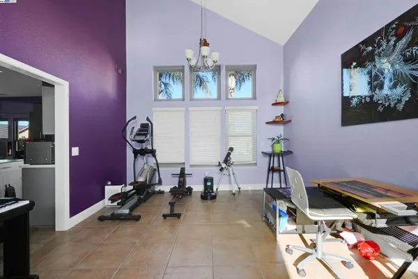 a living room with furniture a dining table and a potted plant