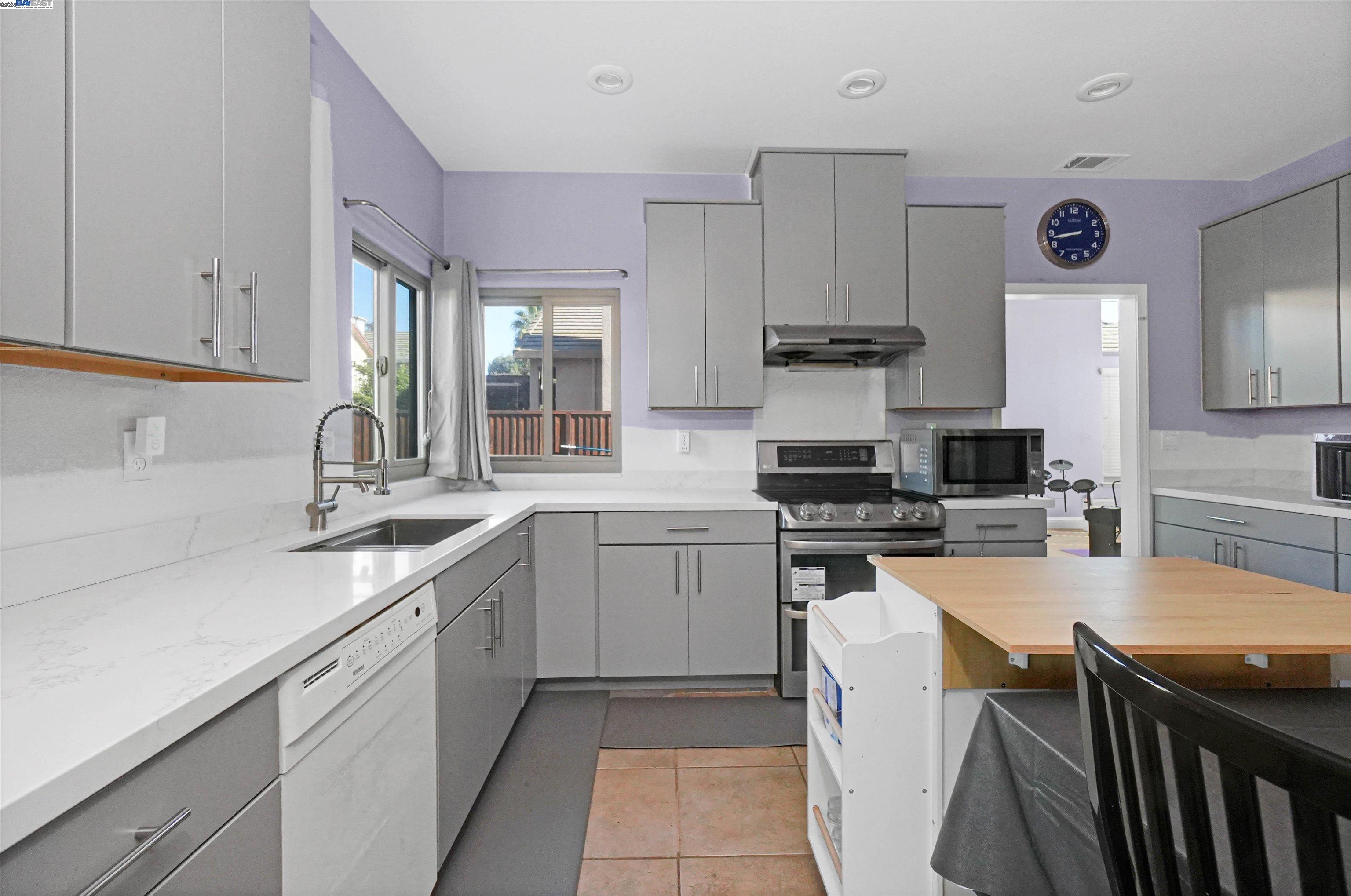 1445 Yorkshire Loop Tracy, CA 95376 - Photo 22 of 55 a kitchen with stainless steel appliances granite countertop a sink stove and refrigerator