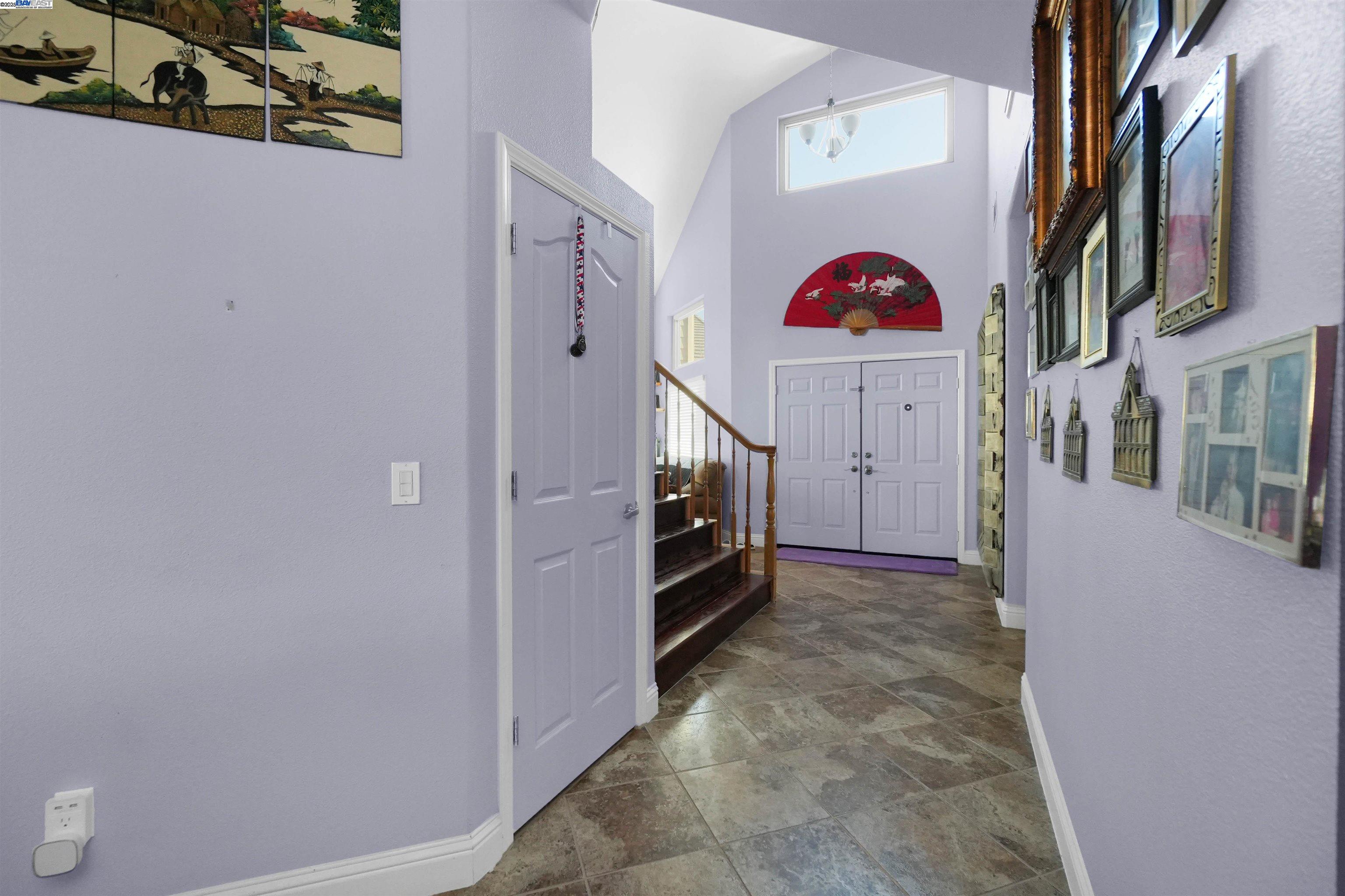 1445 Yorkshire Loop Tracy, CA 95376 - Photo 27 of 55 a view of an entryway with hallway and stairs
