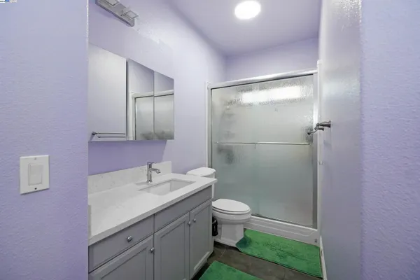 a view of a bathroom with a shower and a sink