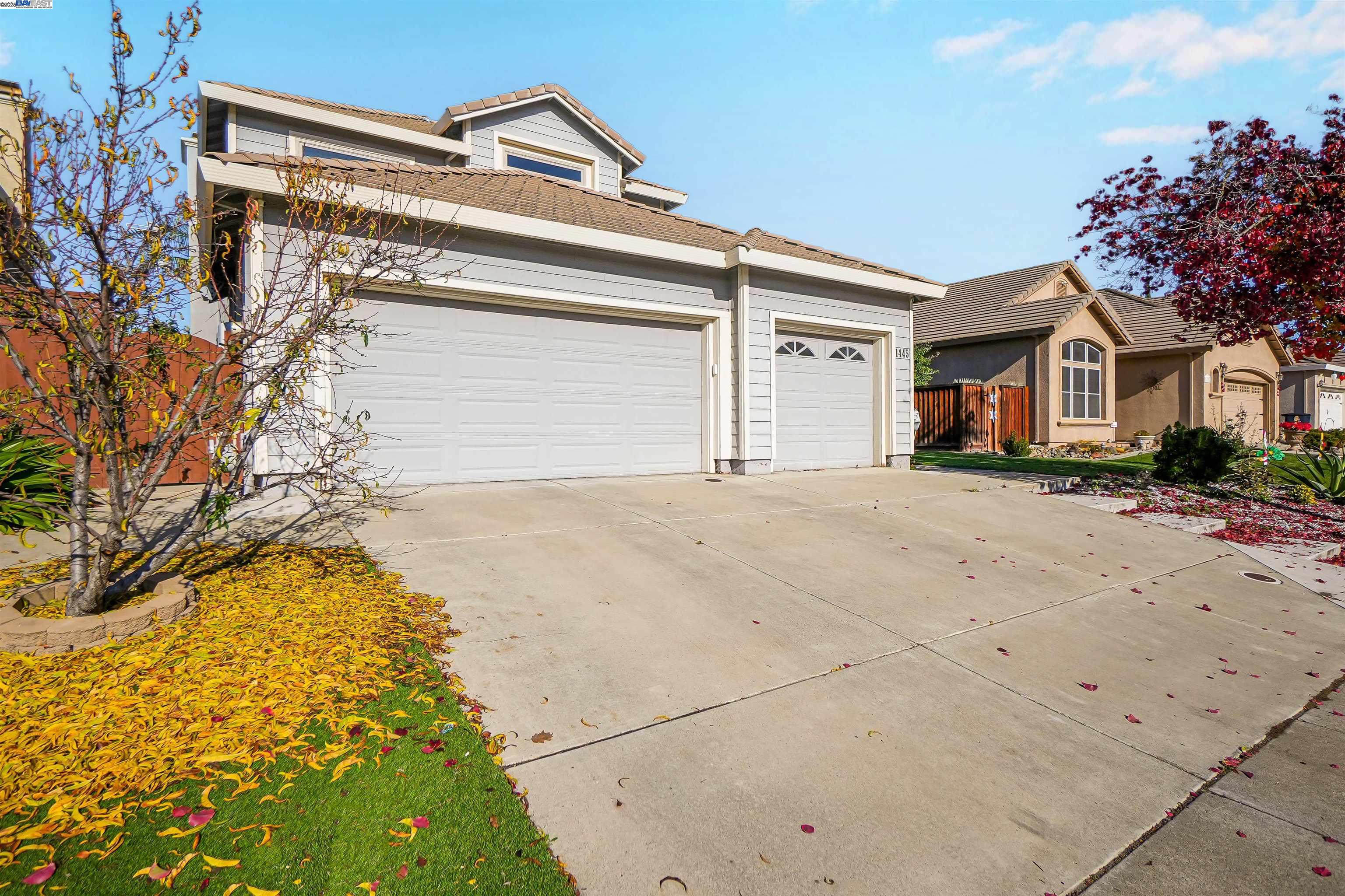 1445 Yorkshire Loop Tracy, CA 95376 - Photo 3 of 55 a front view of a house with a yard and garage