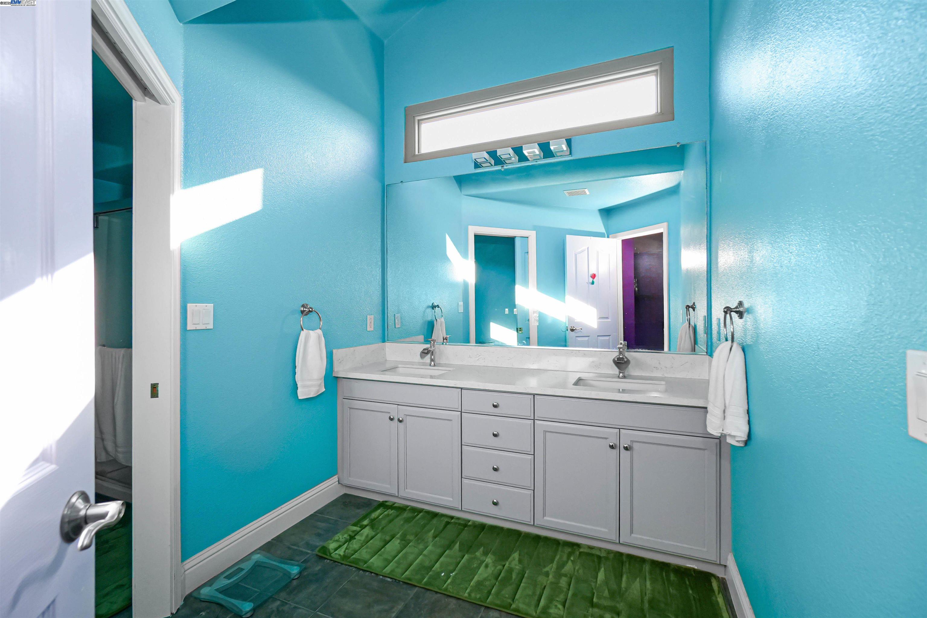 1445 Yorkshire Loop Tracy, CA 95376 - Photo 36 of 55 a spacious bathroom with a double vanity sink and a mirror