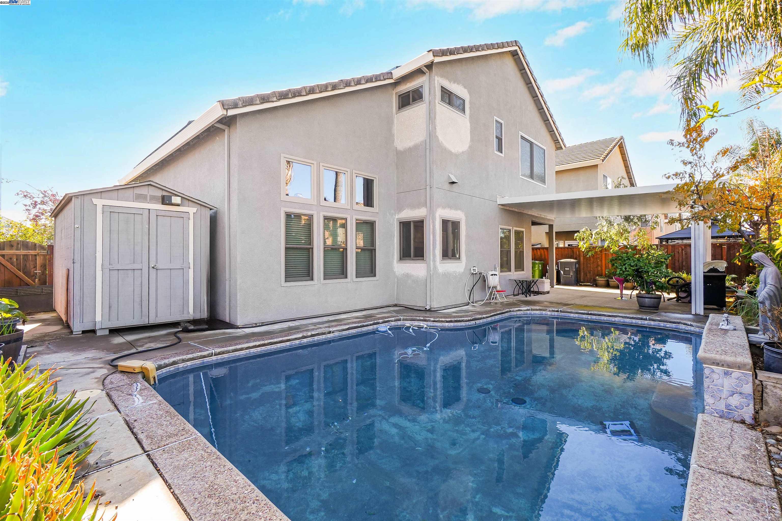 1445 Yorkshire Loop Tracy, CA 95376 - Photo 46 of 55 a view of a house with pool and sitting area