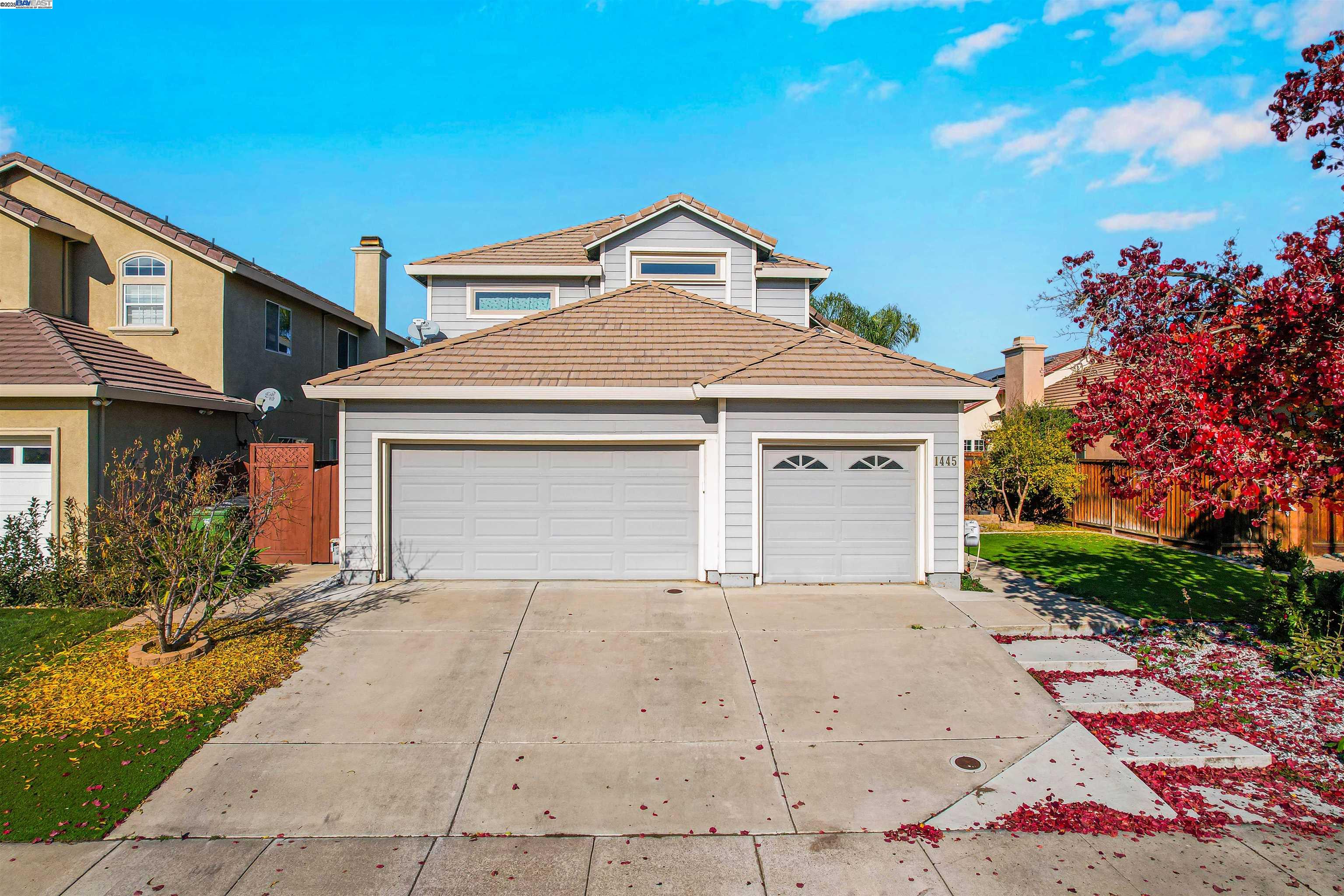 1445 Yorkshire Loop Tracy, CA 95376 - Photo 51 of 55 a front view of a house with a yard and garage