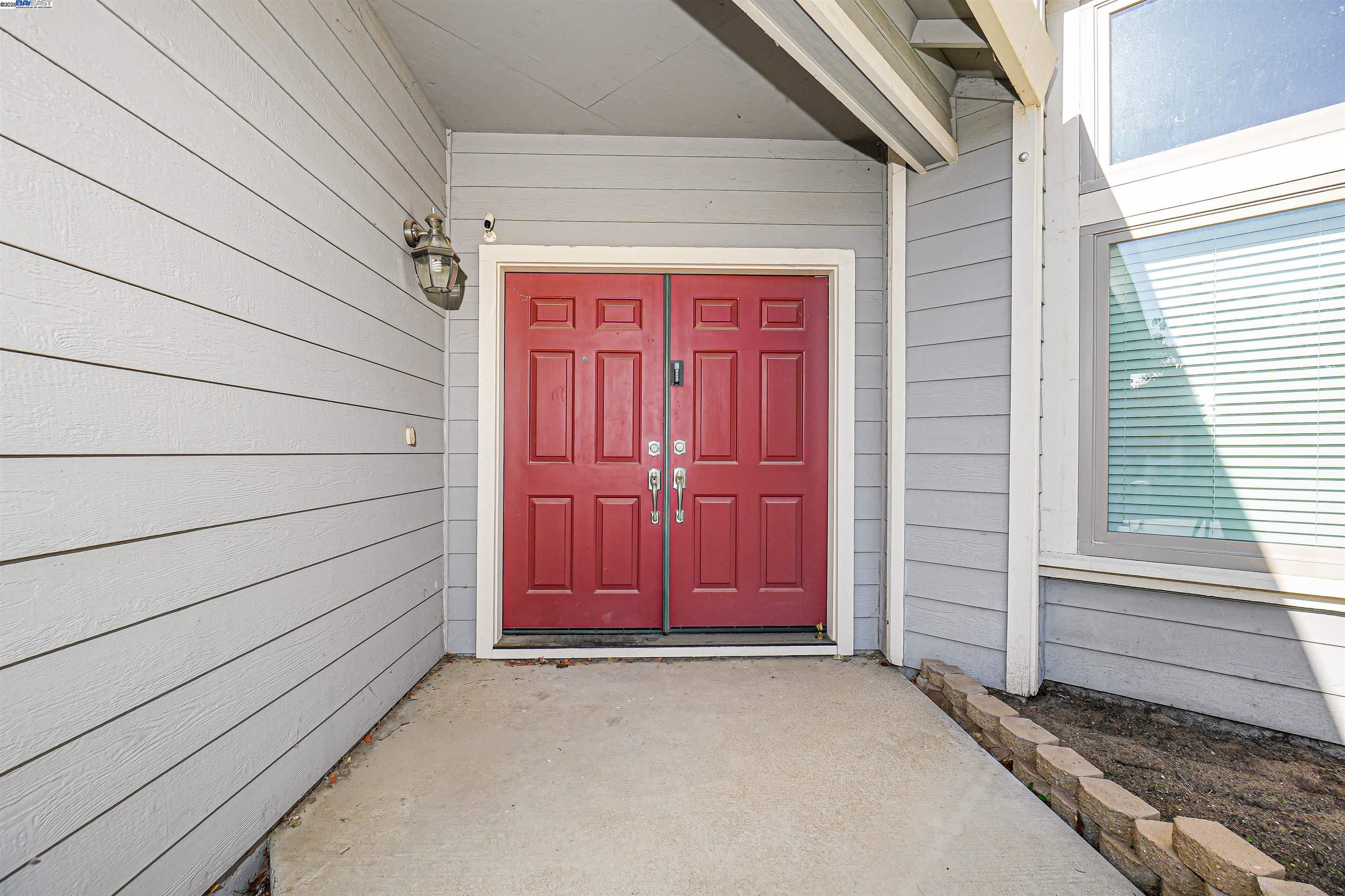 1445 Yorkshire Loop Tracy, CA 95376 - Photo 10 of 55 a view of a house with a wooden door