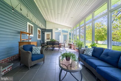 a view of a patio with table and chairs and potted plants