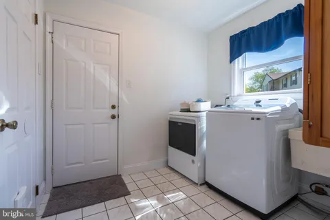 a spacious bedroom with a bed and a flat screen tv