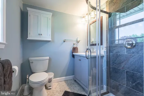 a white toilet sitting next to a bathroom sink