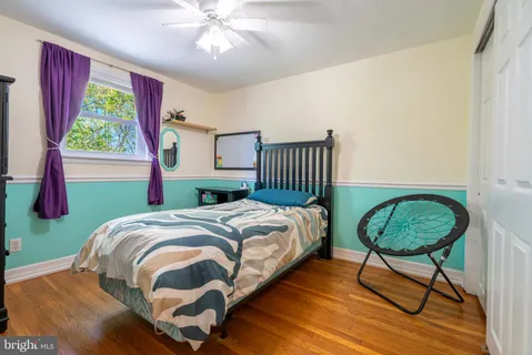 a spacious bedroom with a bed and a chandelier