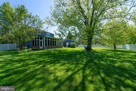 an aerial view of a house with pool outdoor seating and yard
