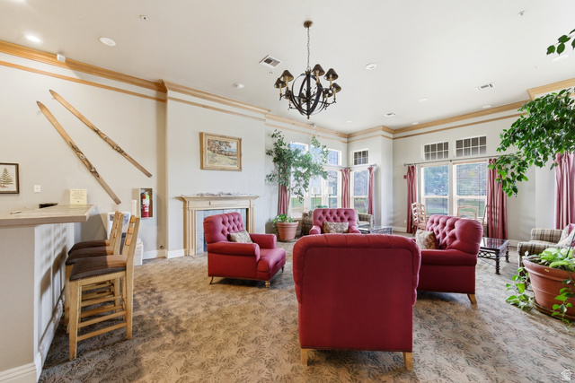 900 Bitner Road, Unit P20 Park City, UT 84098 - Photo 34 of 42 Spacious common area featuring patterned carpet flooring, a decorative chandelier, and extensive fenestration with transom windows