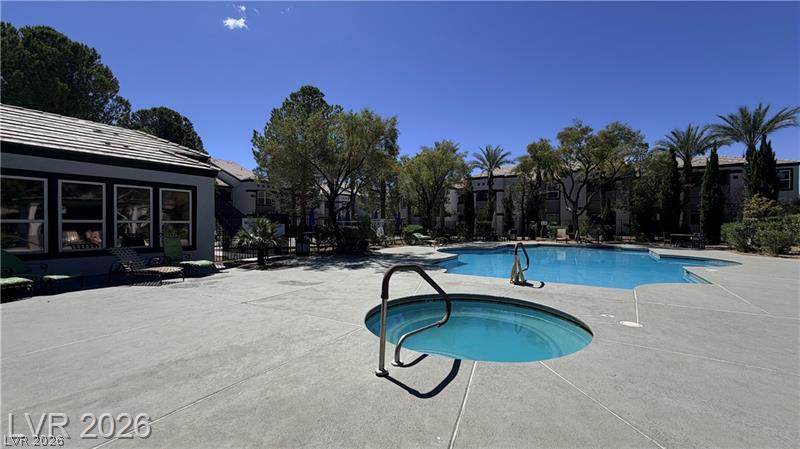 7255 West Sunset Road, Unit 2027 Las Vegas, NV 89113 - Photo 23 of 38 A sparkling community pool and spa are surrounded by mature trees and a spacious concrete deck.