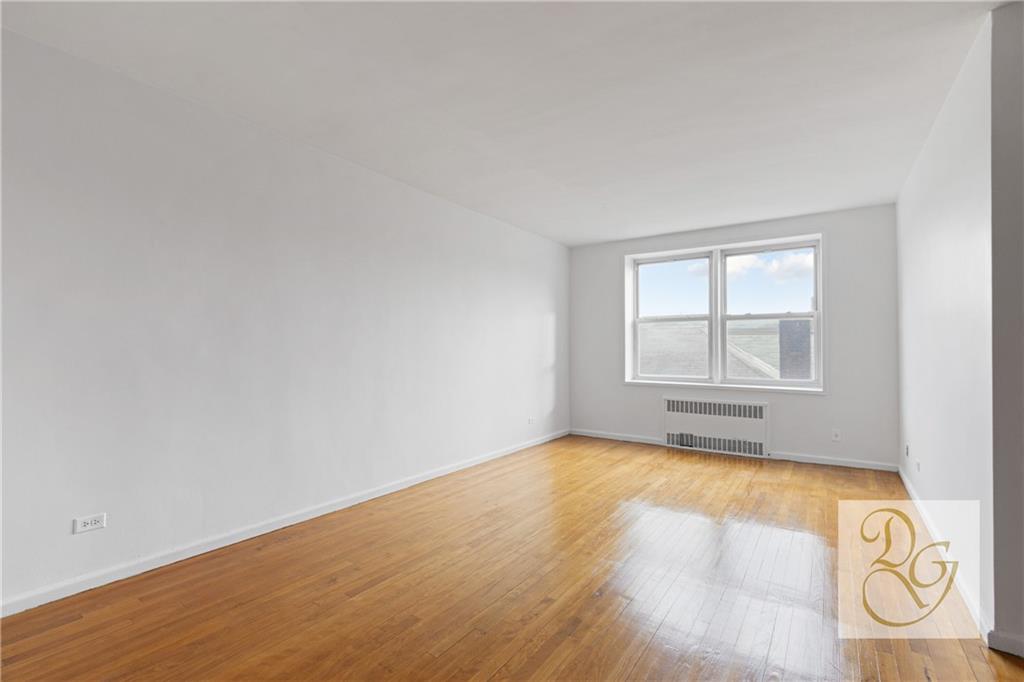 9801 Shore Road, Unit 2O Brooklyn, NY 11209 - Photo 11 of 24 an empty room with window and wooden floor