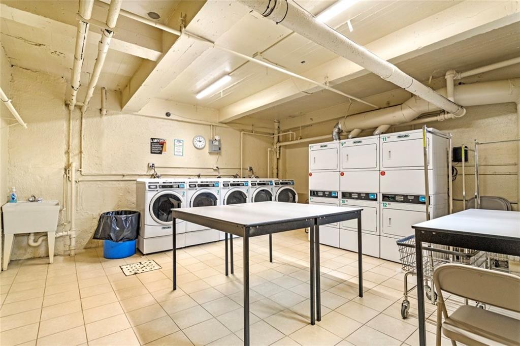 9801 Shore Road, Unit 2O Brooklyn, NY 11209 - Photo 15 of 24 a kitchen with a stove a refrigerator and chairs