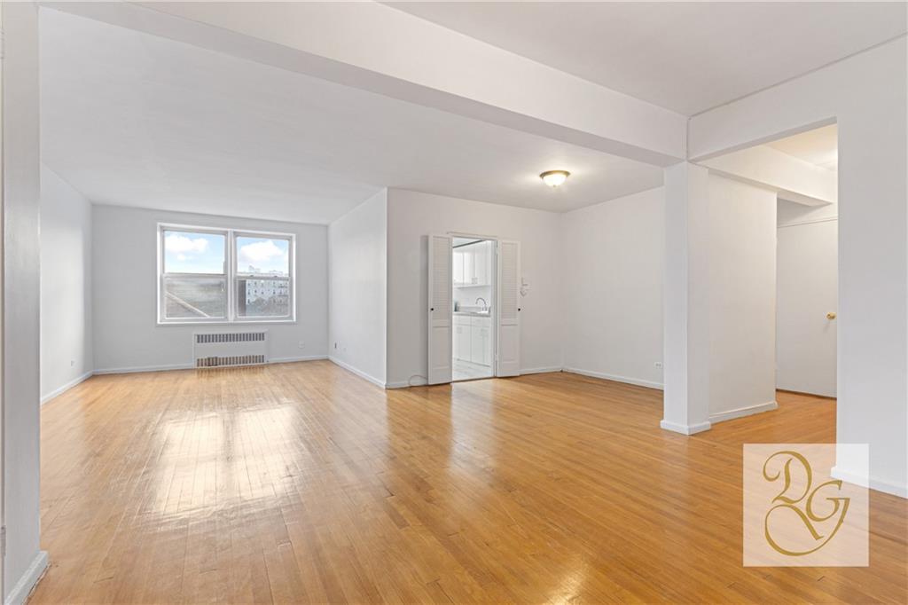 9801 Shore Road, Unit 2O Brooklyn, NY 11209 - Photo 2 of 24 a view of empty room with wooden floor and fan
