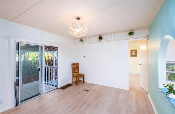 a kitchen with stainless steel appliances kitchen island granite countertop a refrigerator stove oven and white cabinets