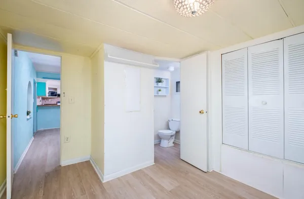 a bathroom with a sink a toilet a shower and a window