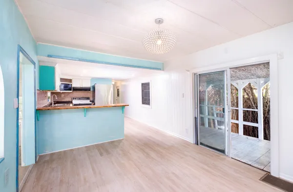 an empty room with windows and hardwood floor
