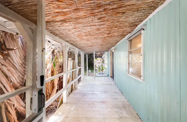 a kitchen with stainless steel appliances granite countertop a refrigerator a sink dishwasher and a fireplace with wooden floor