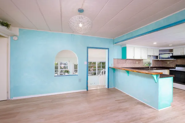 a view of room with wooden floor and furniture
