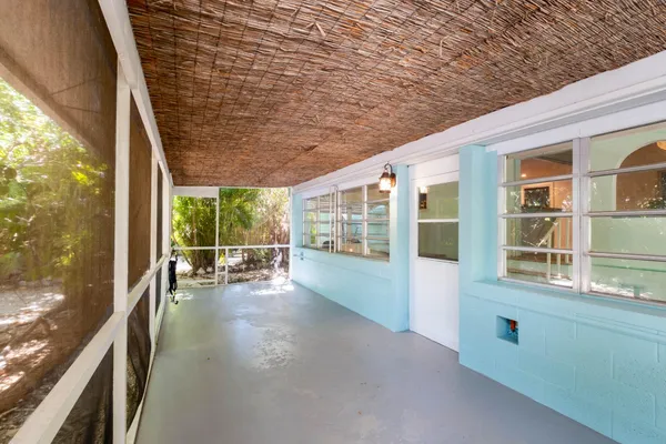 a view of a porch with chairs and floor