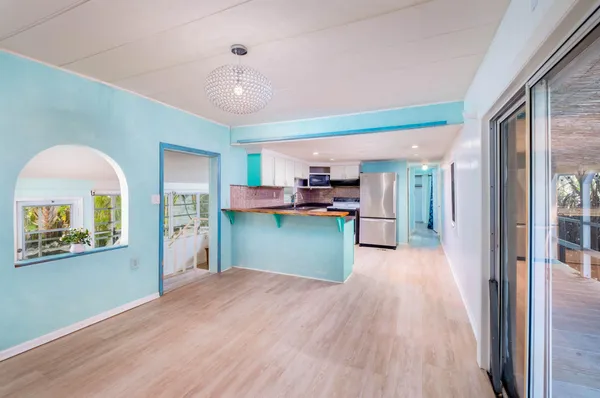 a kitchen with refrigerator and microwave