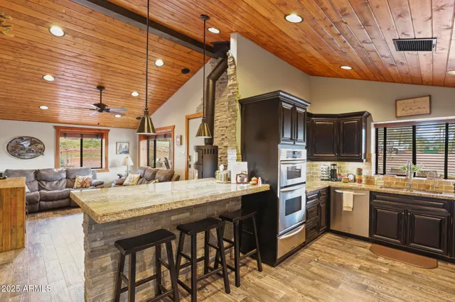 a kitchen with lots of counter top space and stainless steel appliances