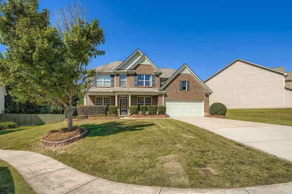 a front view of a house with a yard