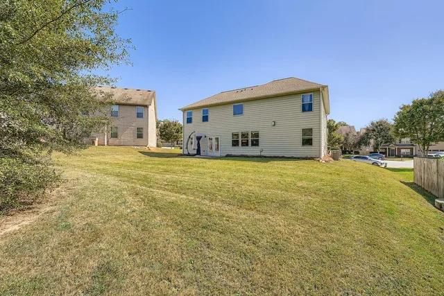 a house view with swimming pool in front of it