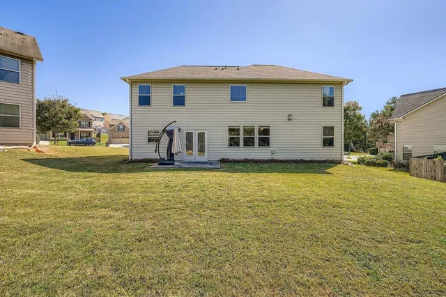 a house view with swimming pool in front of it