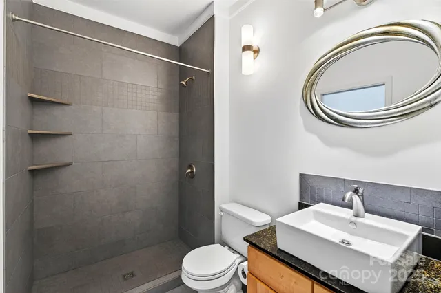 a view of a backyard with plants and outdoor seating